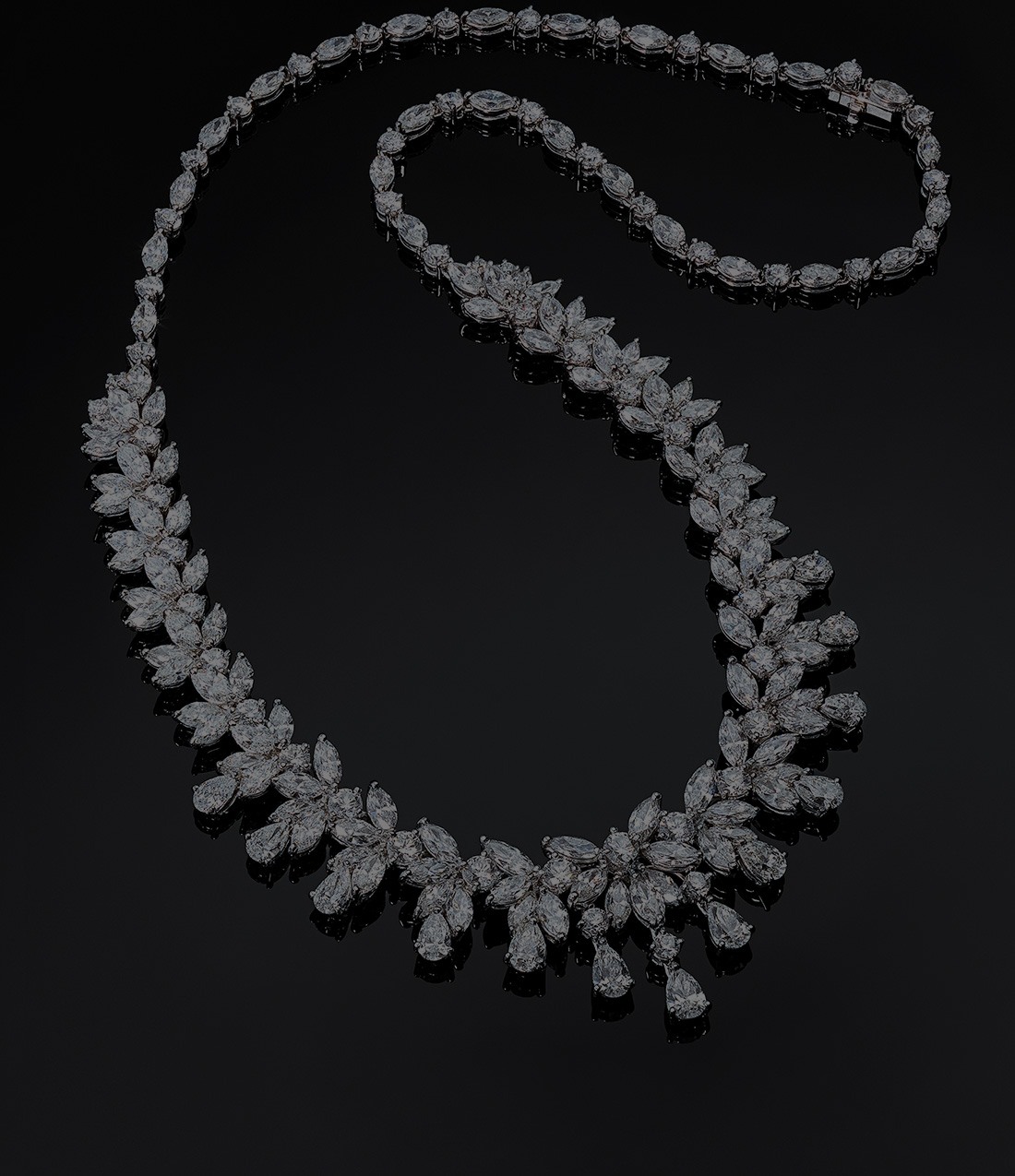 Fancy-shaped Diamond necklace on a glossy black background, shown by Gemcamp