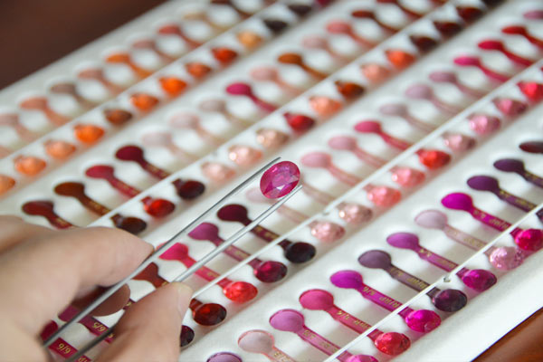 Gemcamp Gemologist grading a heat-treated Ruby or Corundum using our color-reference System