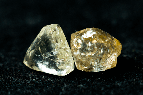 A pair of yellowish diamond macle crystals as uncut specimens from our gemologist